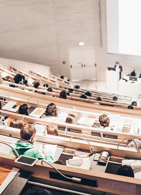 University lecture hall illustration for FiKon, highlighting Marketing Puzzle’s web development and digital marketing services.